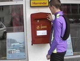 Julian posts his postcards at Hornindal Post Office